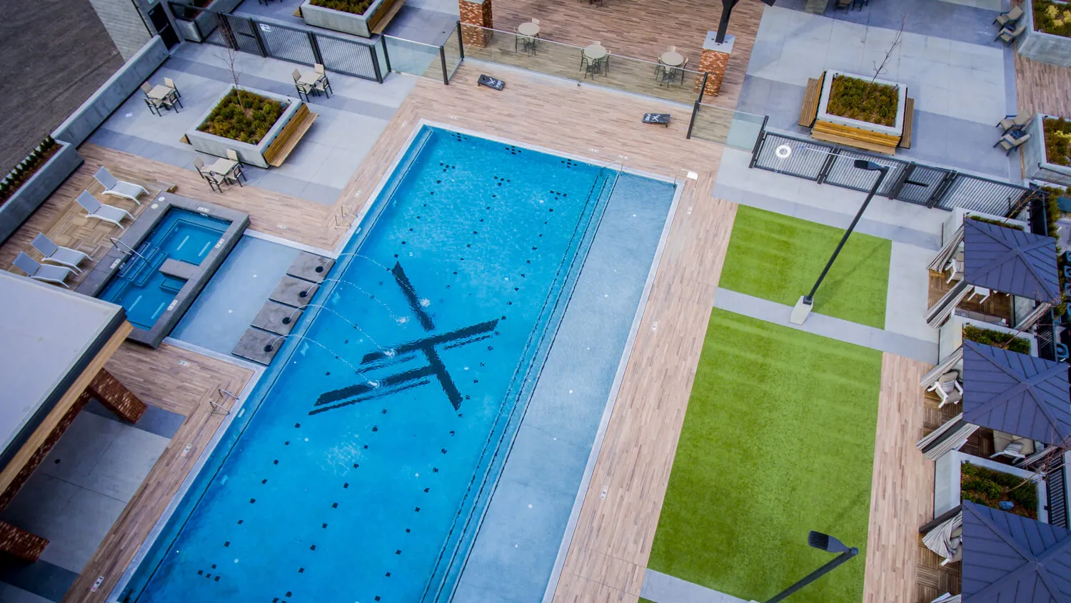 STAND-IN BRANDON TO VET — rooftop pool aerial showing the full deck and skyline