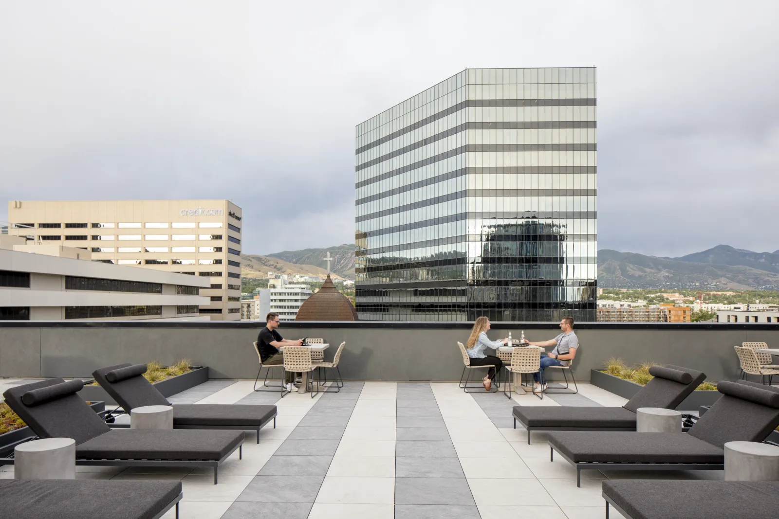 Residents using The Randi rooftop terrace with the Salt Lake City skyline beyond