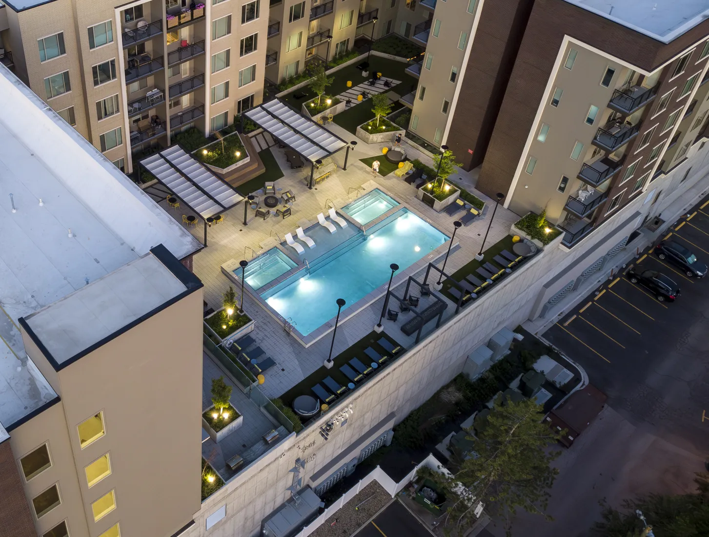 Park Avenue rooftop pool terrace at dusk with the outdoor amenity deck and Sugar House skyline context