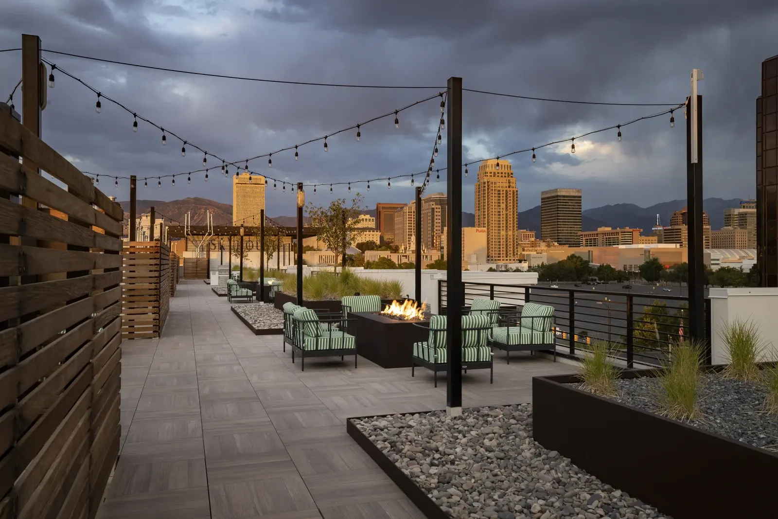 Skyhouse rooftop fire table and skyline at twilight in a marketable resident-use moment